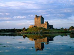 a castle on an island in a body of water at Cosy & Comfy in Kinvara