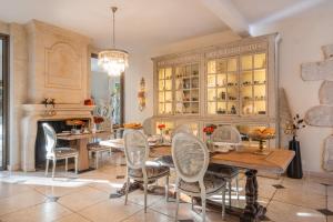 Domaine de la Blonnerie في Feings: غرفة طعام مع طاولة وكراسي وثريا