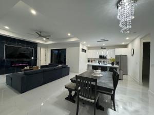 a kitchen and living room with a table and a couch at Dream Family Home Vacation in Cape Coral