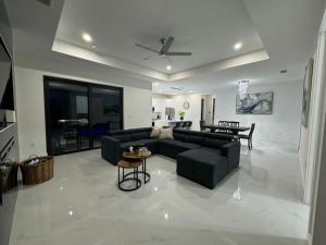 a living room with a couch and a table at Dream Family Home Vacation in Cape Coral