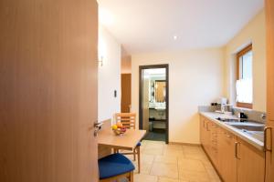 a kitchen with a table and a dining room at Gengs Linde in Stühlingen