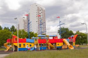 a colorful playground in a park with a building at South Port in Moscow