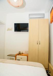a bedroom with a bed and a cabinet and a desk at Bistro Centru Vechi Craiova in Craiova