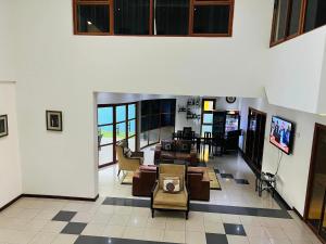 a living room with couches and chairs in a building at TRMOTEL in Matola