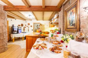 a kitchen with a table with food on it at Appartamento Le Colonne - Relais Villa Quercia in Tassullo