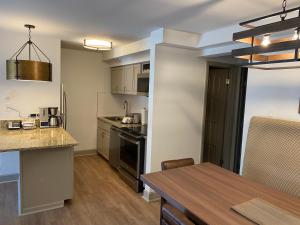 a kitchen and dining room with a table and a counter at Bluegreen's StreamSide at Vail in Vail