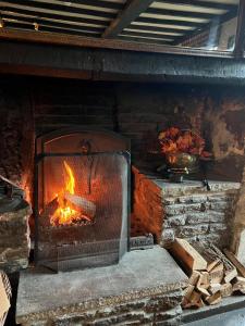 a brick oven with a fire in it at The Red Lion in Lacock