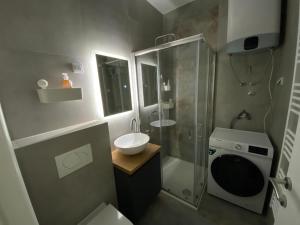 a bathroom with a sink and a shower and a toilet at Zeus in Hiseti +11 photos