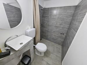 a bathroom with a toilet and a sink and a mirror at Budget Apartment LeLo Centar 5 in Osijek