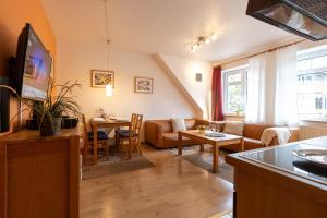 a living room with a couch and a table at ST4-09 - Ferienwohnung in Dorum-Neufeld