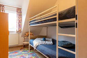a bedroom with two bunk beds and a bed at ST4-09 - Ferienwohnung in Dorum-Neufeld
