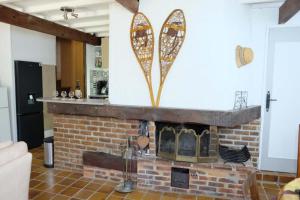 a brick fireplace in a living room with a brick at Sport et réconfort en Couserans in Soulan