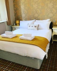 a large bed with two towels on top of it at The Red Lion in Lacock