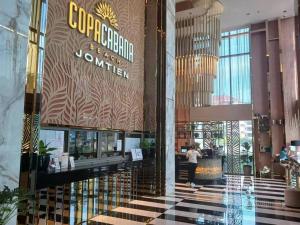 a woman standing in the lobby of a hotel at Copacabana 绝美海景房 59楼无边泳池05 in Jomtien Beach