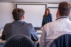 a woman standing in front of a whiteboard in a classroom at H&ocirc;tel du Moulin de la Brevette in Arbigny