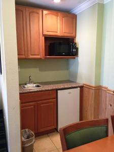 a small kitchen with a sink and a microwave at Surf Motel in San Francisco