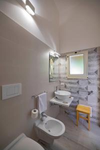 a bathroom with a white toilet and a sink at Agriturismo Le Tagliate in Uggiano la Chiesa