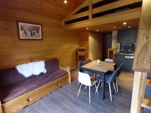 a living room with a couch and a table at Appartement Le Grand-Bornand, 2 pièces, 5 personnes - FR-1-467-26 in Le Grand-Bornand