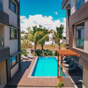 a view of the pool from the balcony of a house at Black Marlin Apartments in Pereybere