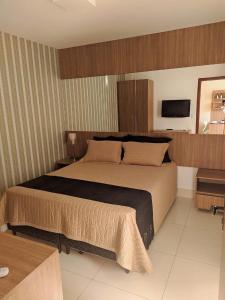 a bedroom with a large bed and a television at Encontro das Águas Thermas resort in Caldas Novas