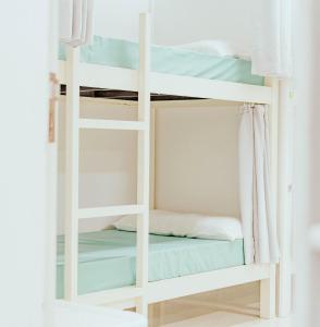 a bunk bed in a room with a window at ALBERGUE ALOXA HOSTEL in Pontevedra