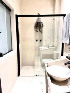 a bathroom with a shower and a toilet and a sink at Santa Cabana - Rio de Janeiro in Rio de Janeiro