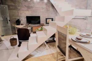a dining room with white walls and a table and chairs at Santa Cabana - Rio de Janeiro in Rio de Janeiro