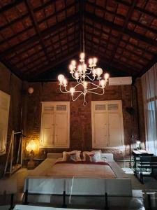 a chandelier in a room with a bed and a table at Santa Cabana - Rio de Janeiro in Rio de Janeiro