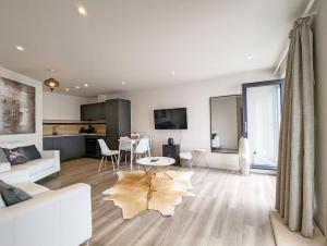 a living room with a white couch and a table at West Lodge, Bognor Regis in Bognor Regis