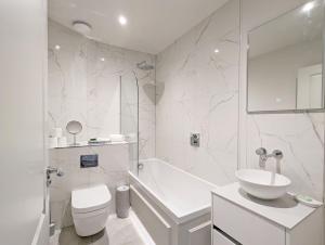 a bathroom with a sink and a toilet and a tub at West Lodge, Bognor Regis in Bognor Regis +18 photos
