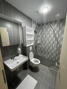a bathroom with a toilet and a sink at Naš Dom Hotel in Bijelo Polje
