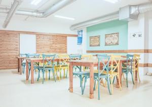 a group of tables and chairs in a room at ALBERGUE ALOXA HOSTEL in Pontevedra