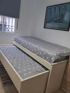 a mattress on top of a bed in a room at Centrico, Parking incluido in Jaén