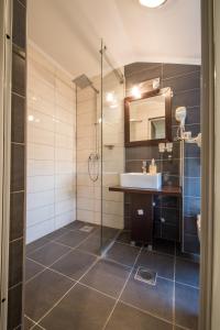 a bathroom with a sink and a glass shower at Villa Milano in Kovin +18 photos