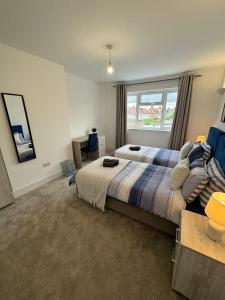 a bedroom with a large bed and a window at Smart ROOMS Easy access to Central London By Piccadilly Line in New Southgate