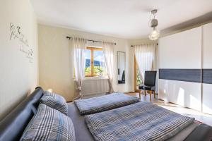 a bedroom with two beds and a couch at Südalb in Albstadt