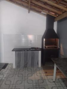 a kitchen with a stove top oven in a room at Casa perto da praia mobiliada in Itanhaém