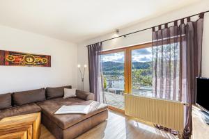 a living room with a couch and a large window at Südalb in Albstadt