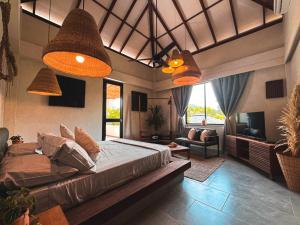 een slaapkamer met een bed en een woonkamer bij MAPUWI Villa & Suite in Palomino +37 foto's