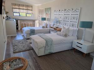 a living room with two beds and a couch at Milky Way in Hermanus