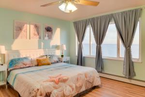 a bedroom with a bed with a starfish bedspread at Oceanfront Kenai Villa with Fireplace and Deck in Kenai