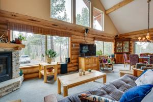 a living room with a couch and a fireplace at Rustic Ward Retreat with Deck and Mountain Views! in Ward