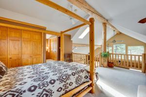 a bedroom with a bed and a balcony at Rustic Ward Retreat with Deck and Mountain Views! in Ward