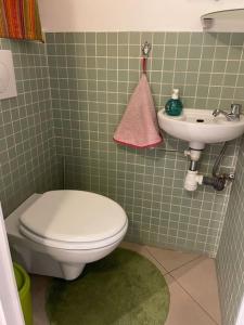 a bathroom with a toilet and a sink at Appartement de 90m² en souplex in Paris