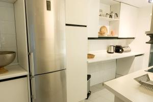 a kitchen with a stainless steel refrigerator at LUX Apt Puerto Banus-Pool-Terrace 5 min to beach in Marbella