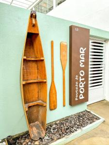 un barco de madera y una cuchara de madera en la pared en Pousada do Porto Mar, en Porto de Pedras