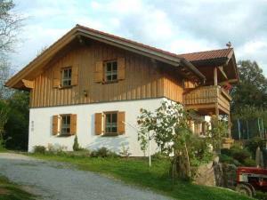 une maison avec un toit en bois dans une rue dans l'établissement Ponyhof Killinger, à Zwiesel