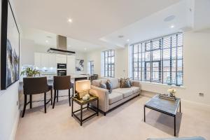 a living room with a couch and a table at Palace Wharf in London