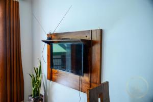 a television is hanging on a wall at Kapri Luxury Apartment in Nuwara Eliya