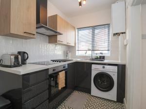 a kitchen with a washing machine and a sink at 11a Manning Road in Felixstowe